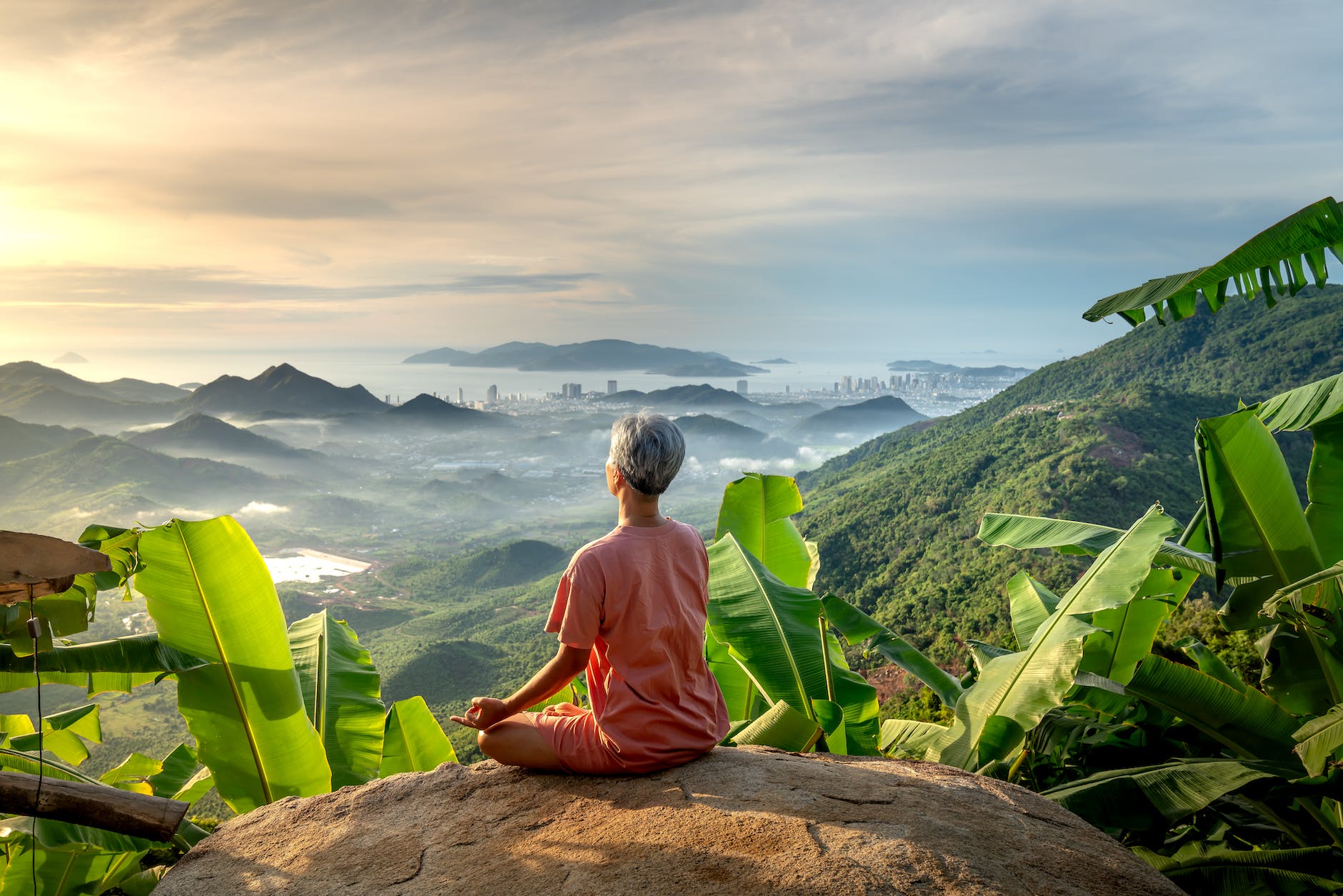 woman looking at beautiful landscape and doing yoga