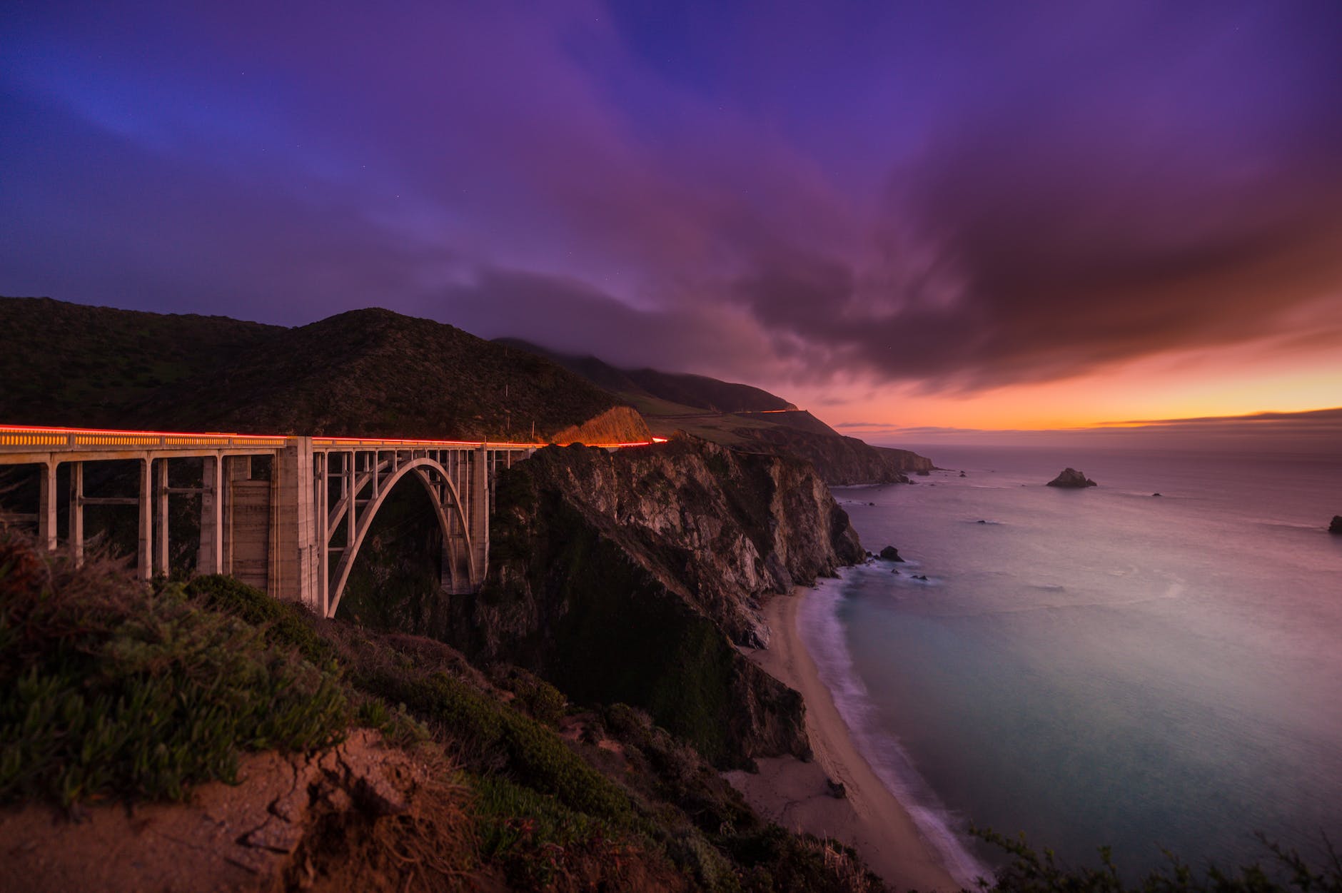 metal bridge on beach during sunset