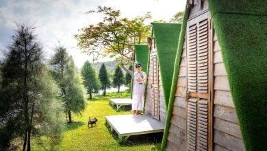 woman standing on porch of bungalow in camping