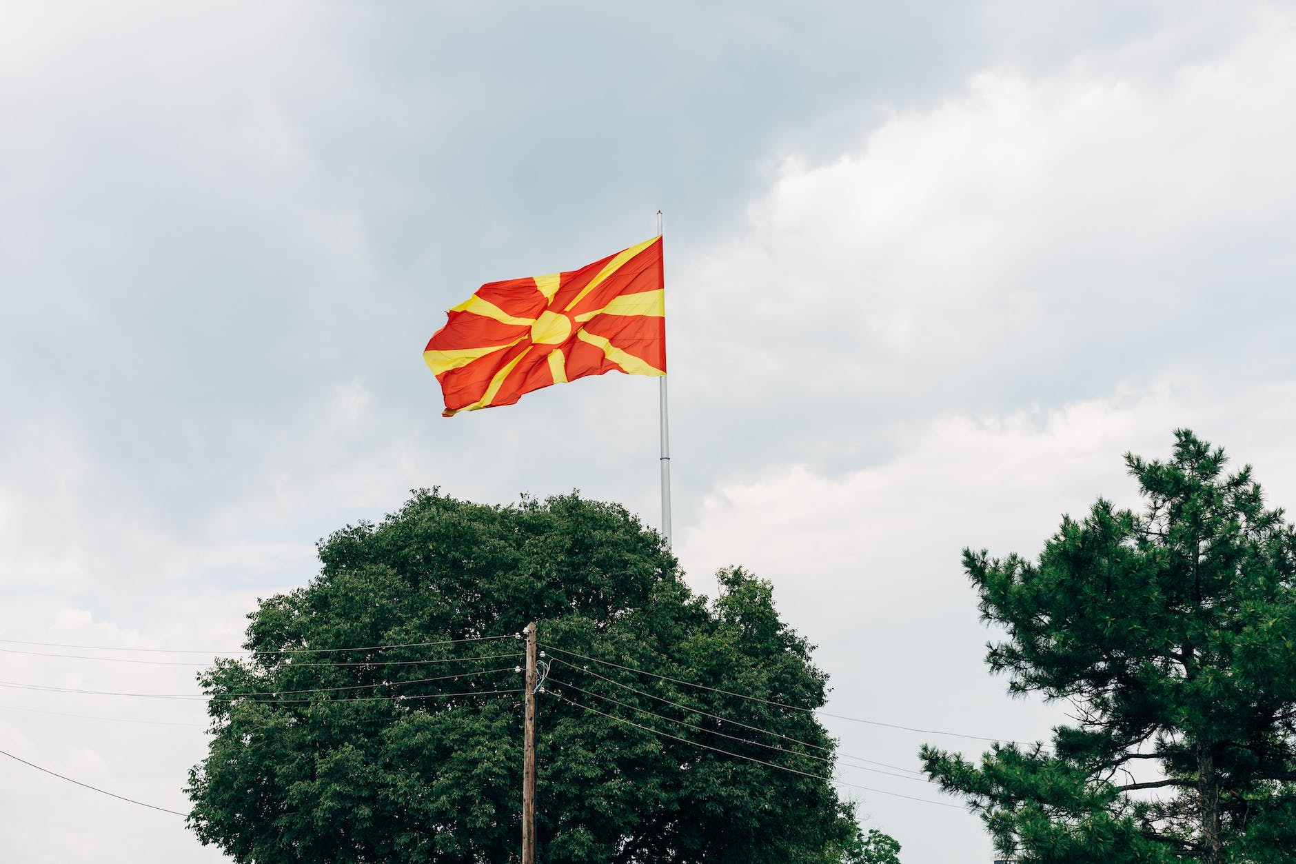 waving flag of north macedonia under cloudy sky