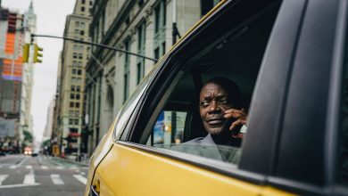 man sitting by the window of a yellow car