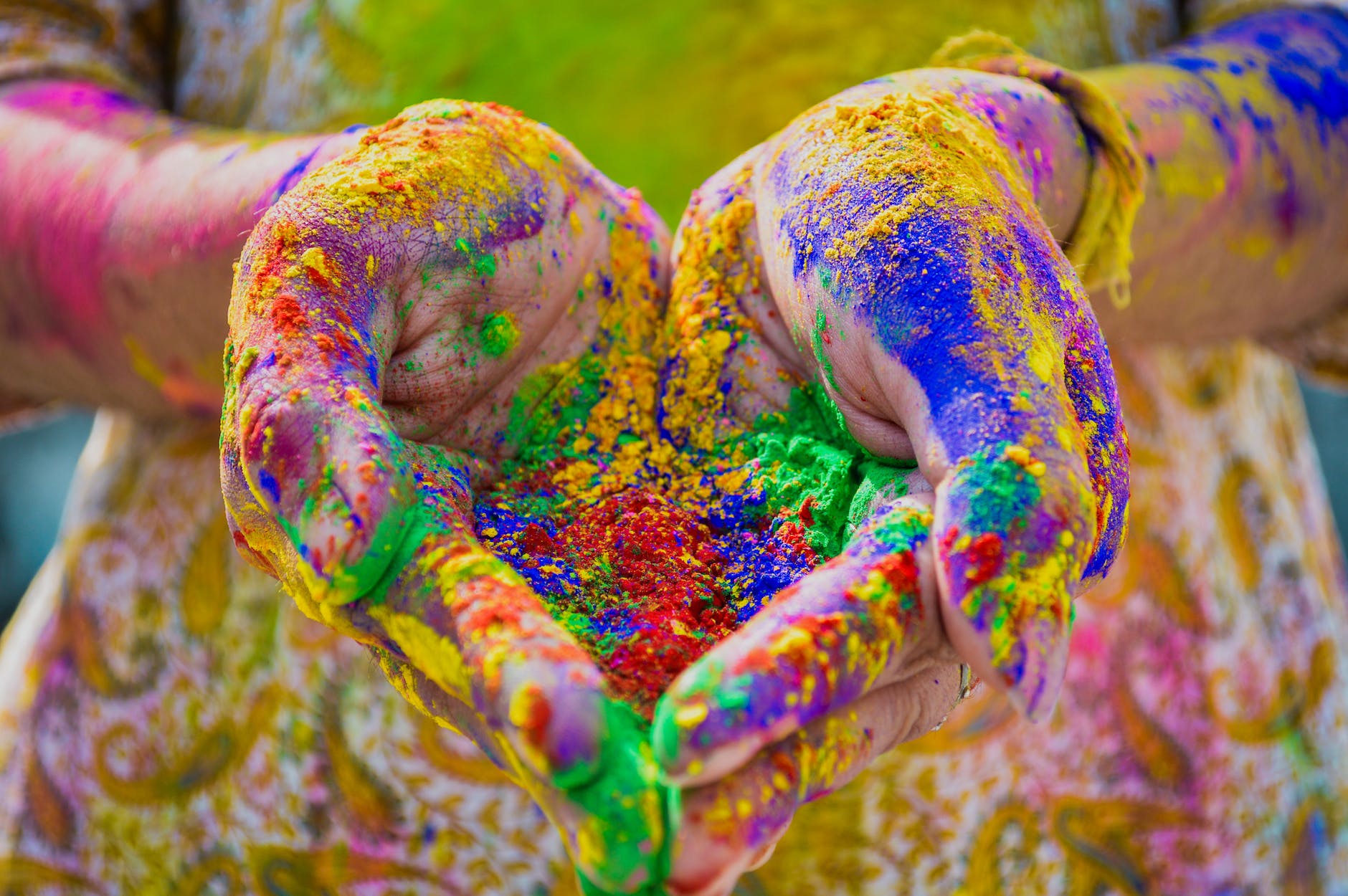 person s hand full of colored powder